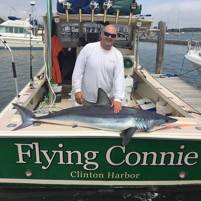 Captain Mike with a Shark Caught Aboard the Flying Connie