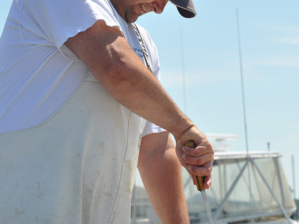 Captain Mike Cleaning Fish Caught Aboard the Flying Connie Charter Boat