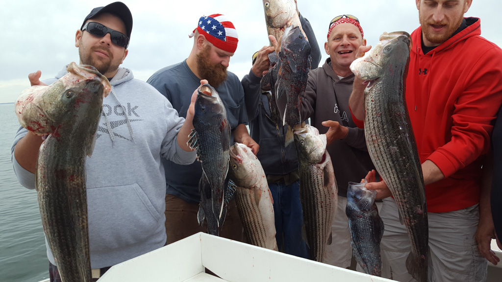 Group of Friends Holding Fish They Caught on a Charter Boat